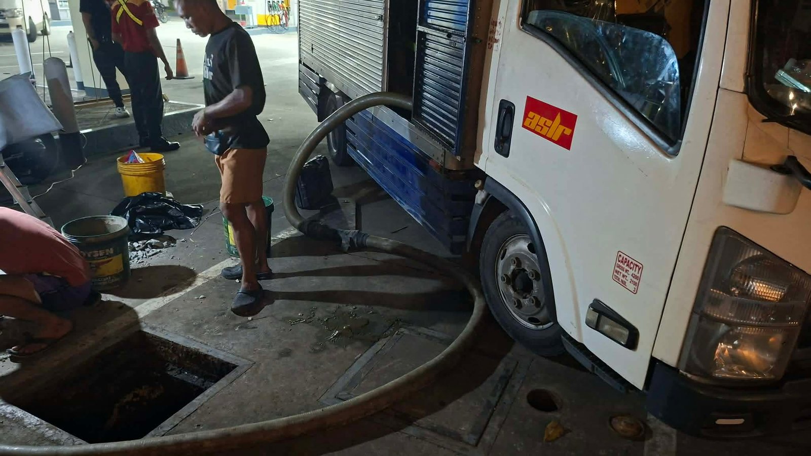 Queen Malabanan siphoning truck and crew on a night job